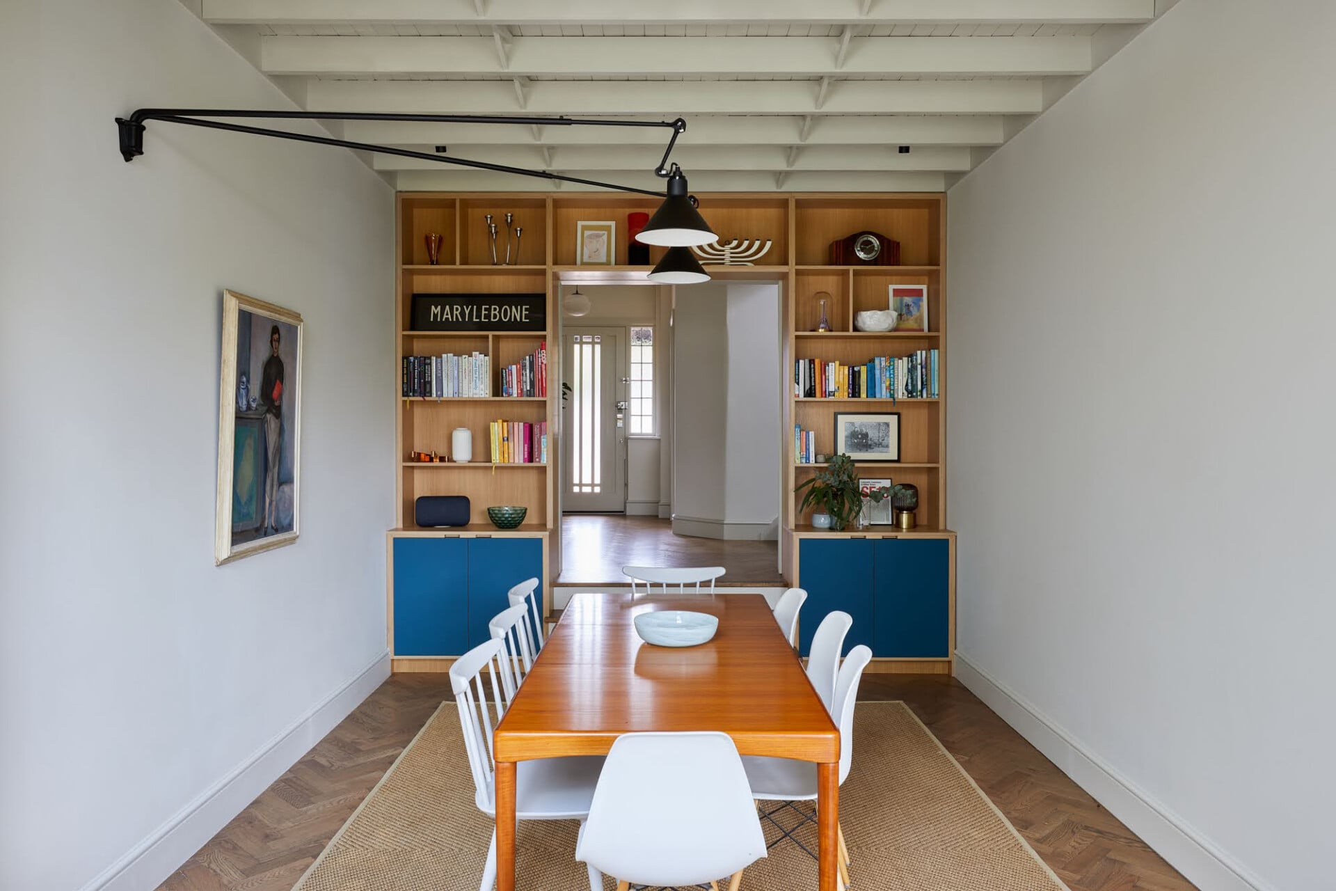 Minimalist plywood dining area in London with built-in shelving