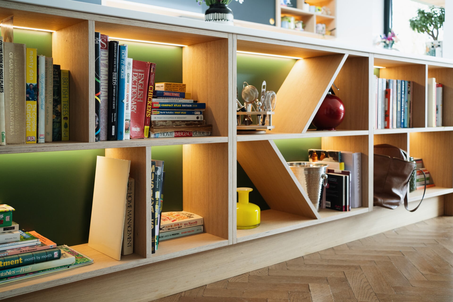 Colourful open shelving with books and decor in modern London kitchen