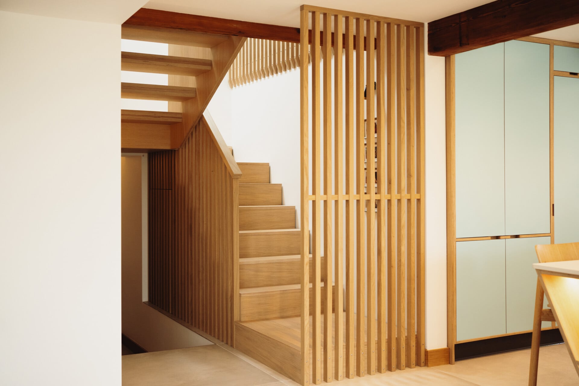 contemporary Oak staircase with vertical timber balustrade and natural light